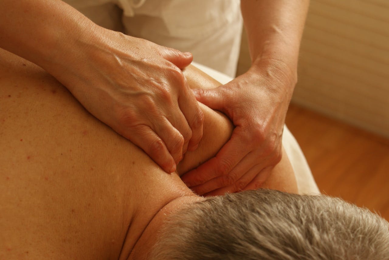 services-02 Close-up of a therapist giving a relaxing shoulder massage, enhancing wellness and stress relief.
